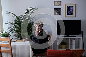 Bereaved woman alone at home photo
