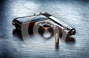 Beretta pistol with 9mm caliber bullet photo