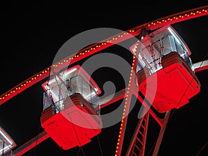 Bergamo, Italy. The Ferris wheel illuminated in red in the evening. Christmas time