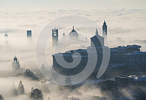 Bergamo, Italy. Lombardy. Amazing landscape of the fog rises from the plains and covers the old town