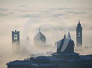 Bergamo, Italy. Lombardy. Amazing landscape of the fog rises from the plains and covers the old town