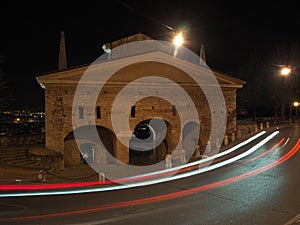 Bergamo, Italy. The old city. Landscape at the old gate San Giacomo door during the evening with trails of headlights