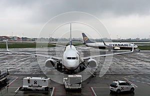 2019.05.20 Bergamo, Orio al Serio airport plane parked in the foreground with airplane Ryanair ready to take off in the background