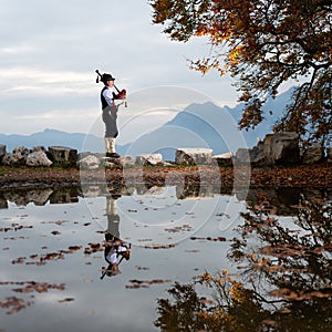 Bergamo player Bagpipe is reflected in a pool of water