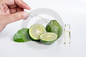 Bergamot serum, organic products made from natural concept. woman hand holding glass dropper for dermatologist testing