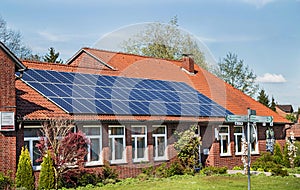 Bergen, Germany - April 30, 2017: Solar energy panel on a house roof on the blue sky background.