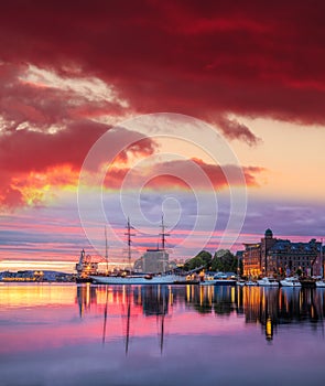 Bergen harbor with boats against colorful sunset in Norway, UNESCO World Heritage Site