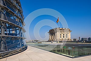 Berlin, Germany - Rooftop of the Reichstag building with the glass panoramic Bundestag dome and historic corner tower with Germany