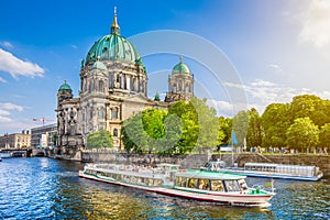 Berlin Cathedral with boat on Spree river at sunset, Germany