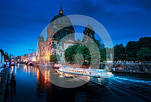 Berlin Cathedral with excursion boat on Spree river,