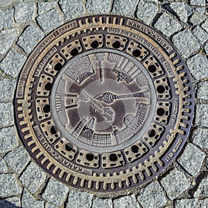 ron plate at entrance to sewage system with emblem of landmarks in Berlin