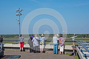 Airplane spotters looking at airplanes at the observations deck at Berlin Tegel airport