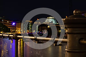 Berlin, Germany - August 25, 2019 - German Bundestag, seat of the parliament, with bridge and a blurred fence in the foreground at