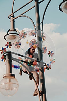 Berlin, Germany - 7/27/2019: Christopher street day in Berlin, street art performer on a light pole. Berlin pride.