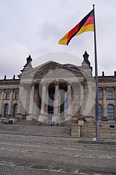 Berlin, Germany: facade of the Reichstag building, the German Parliament, and flag