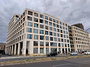 Big modern corner office building with beige facade