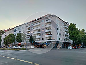 Municipal residential building with balconies and pink facade on the corner of the crossroad