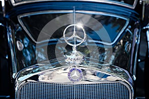 Mercedes Benz star logo design / brand name on Oldtimer automobile in Berlin, Germany
