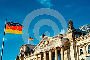 Berlin, Germany - MAY, 2017 : German flag fluttering in the wind in front of Reichstagin in a clear summers day