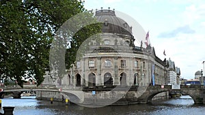 BERLIN - GERMANY, MAY 23, 2017, Bode museum in sunny day with pleasure boat on Spree river on blue sky background. River Island