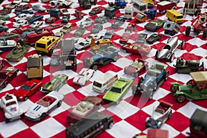 Colorful small toy cars placed on red and white fabric in Flohmarkt im Mauerpark market in Berlin