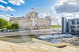 Berlin government district with Reichstag and ship on Spree rive