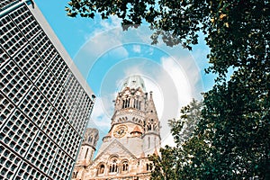 Berlin Kaiser Wilhelm Memorial Church tower surrounded by tree. photo