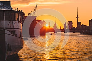 Berlin skyline with old ship wreck in Spree river at dusk, Germany