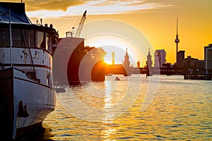 Berlin skyline with old ship wreck in Spree river at sunset, Germany