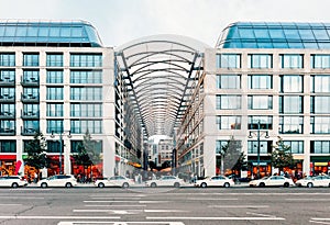 Berlin taxis waiting outside modern shopping centre.