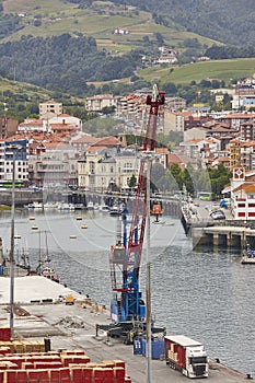 Bermeo commercial harbor and pier with crane. Basque country