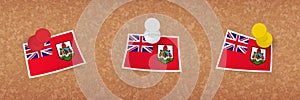 Bermuda flag pinned in cork board, three versions of Bermuda flag
