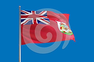 Bermuda national flag waving in the wind on a deep blue sky. High quality fabric. International relations concept