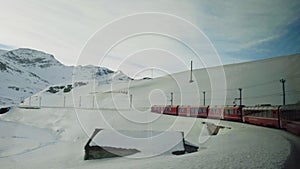 The Bernina Express Red Train passing through the Alps