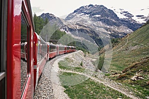 Bernina express on Switzerland. It is landmark of Swiss Alps. Nice Alpine landscape in summer. Red glacier train on photo