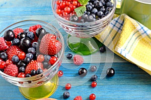 Berries of red-blue color on a blue background healthy food