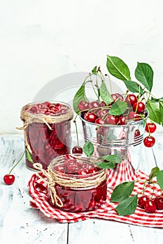 Berries cherry with syrup. Berries cherry with syrup. Canned fruit on a light background. vertical image. place for text