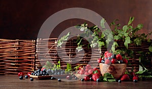 Berries closeup colorful assorted mix of strawberry, blueberry, raspberry and sweet cherry on a old wooden table