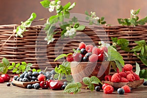 Berries closeup colorful assorted mix of strawberry, blueberry, raspberry and sweet cherry on a old wooden table