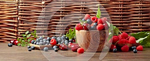 Berries closeup colorful assorted mix of strawberry, blueberry, raspberry and sweet cherry on a old wooden table