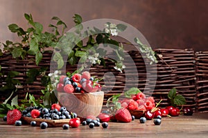 Berries closeup colorful assorted mix of strawberry, blueberry, raspberry and sweet cherry on a old wooden table