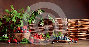 Berries closeup colorful assorted mix of strawberry, blueberry, raspberry and sweet cherry on a old wooden table