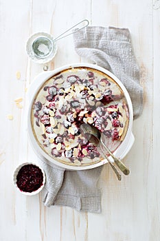 Berries, cream and almond homemade pie in white cooking tray