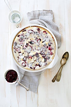 Berries, cream and almond homemade pie in white cooking tray