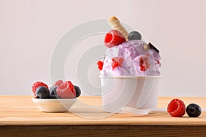 Berries ice cream cup decorated with blueberries and raspberries