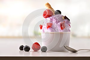 Berries ice cream cup on white table homemade in kitchen