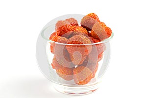 Berries of organic sweet strawberries in a glass cup on a white background, close-up, isolate. Place for text, copy space