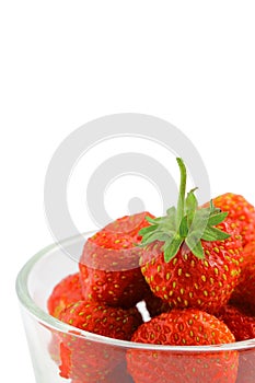 Berries of organic sweet strawberries in a glass cup on a white background, close-up, vertical frame,  isolate. Place for text,