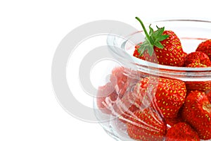 Berries of organic sweet strawberries in a glass jar on a white background, close-up, isolate. Place for text, copy space