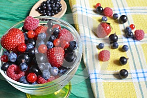 Berries of red-blue color on a green background healthy food
